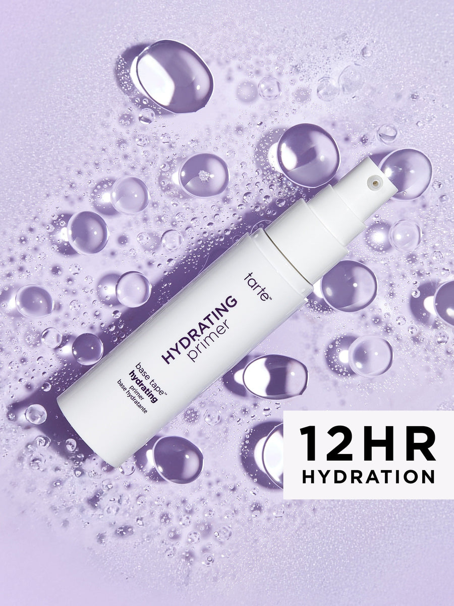 Hydrating primer bottle with water droplets on a purple background