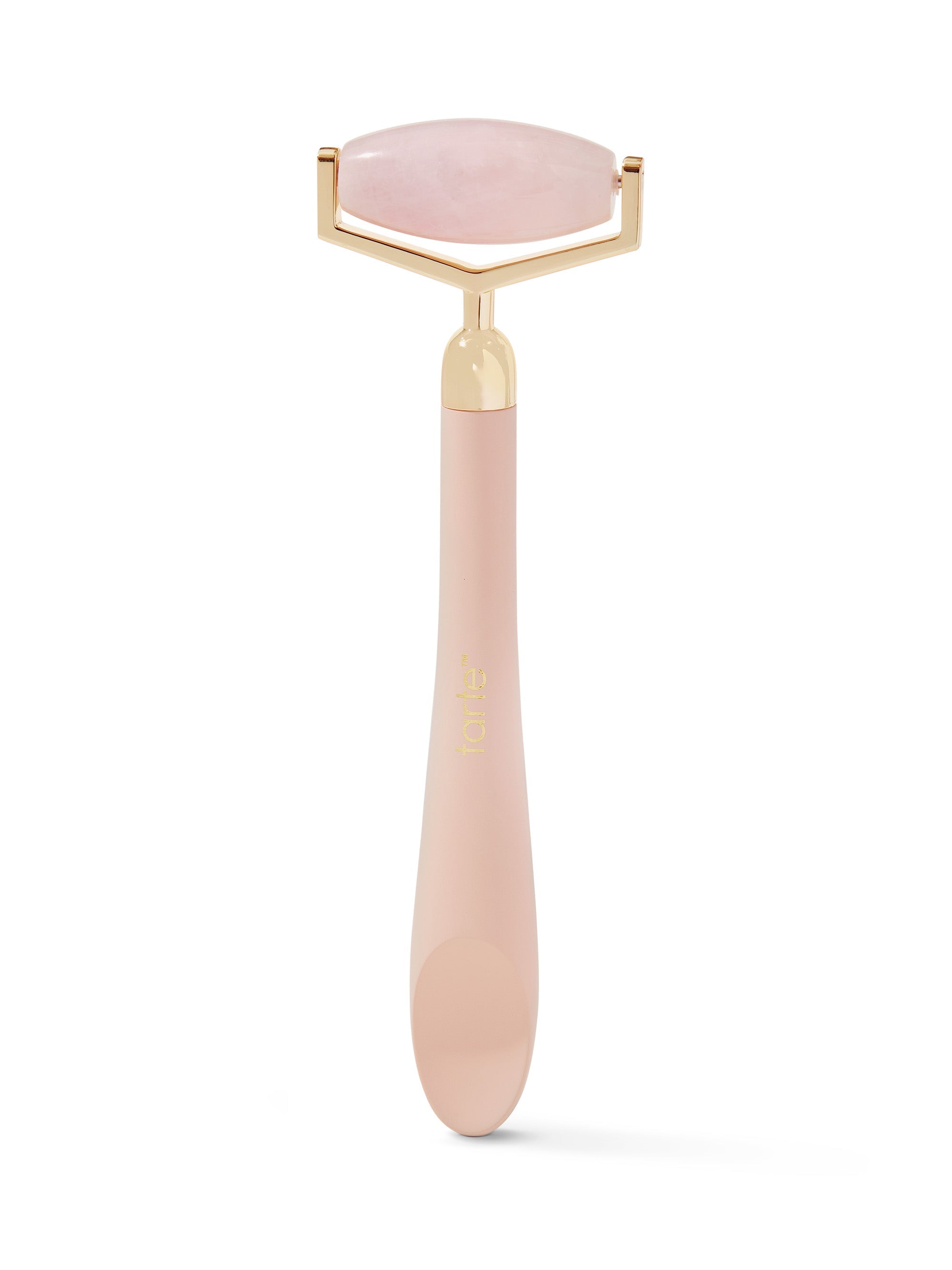 Pink facial roller with gold accents on a white background