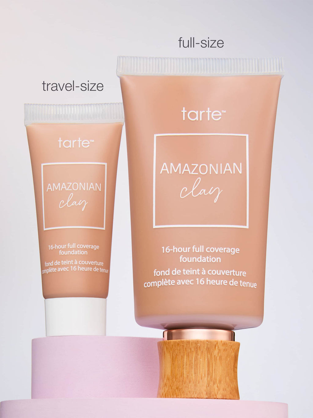 Two Tarte Cosmetics foundation tubes, one labeled travel-size and the other full-size, are positioned on pastel platforms. Text: AMAZONIAN clay 16-hour full coverage foundation.