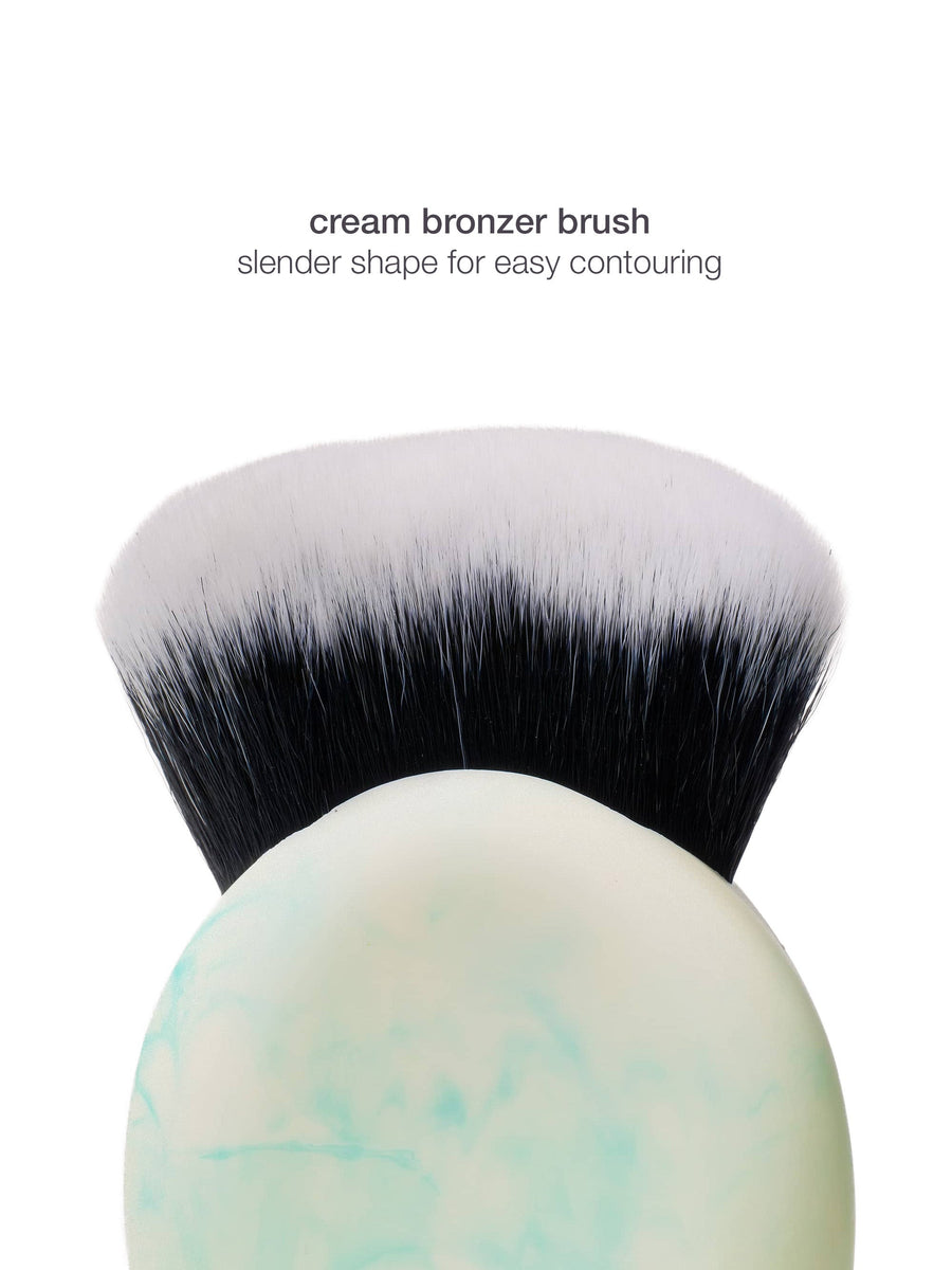 Cream bronzer brush with black bristles on a white background