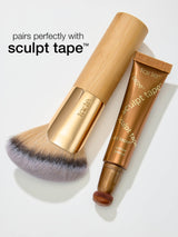 Tarte makeup brush and sculpt tape on a white background