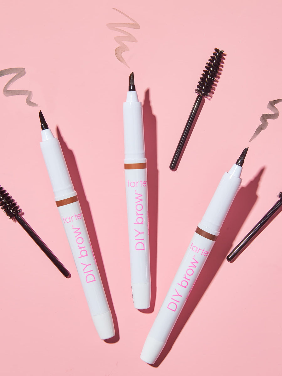 Set of 'Huda Beauty DIY Brow' products on a pink background