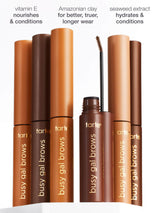 Brow gel tubes with brush applicator stand upright, displaying shades of brown. Labels read busy gal brows. Text highlights: vitamin E nourishes & conditions, Amazonian clay for better, truer, longer wear, seaweed extract hydrates & conditions.