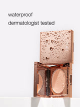 Rose gold compact with water droplets and 'waterproof dermatologist tested' text on a white background