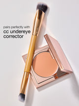 Makeup product with a brush and text on a light background