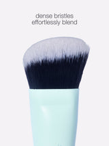 Makeup brush with dense bristles on a light gray background