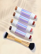 Set of tarte maracuja juicy double ended multi stick  with brushes  on a beige background