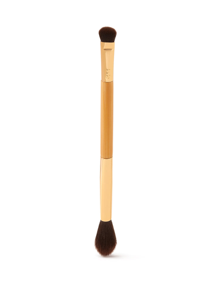 Makeup brush with wooden handle and black bristles on a white background