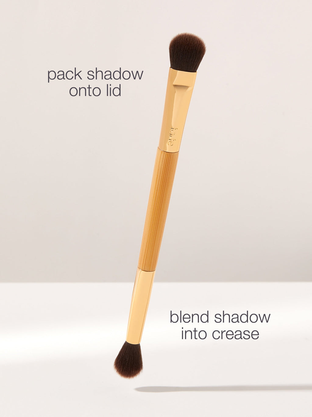 Makeup brush with text instructions on a light gray background