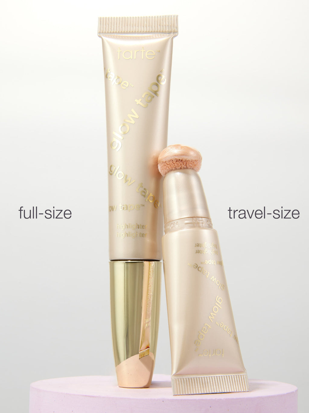 Full-size and travel-size cosmetic tubes on a light gray background