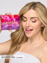 Woman holding a Tartelette in Bloom makeup palette with a white background
