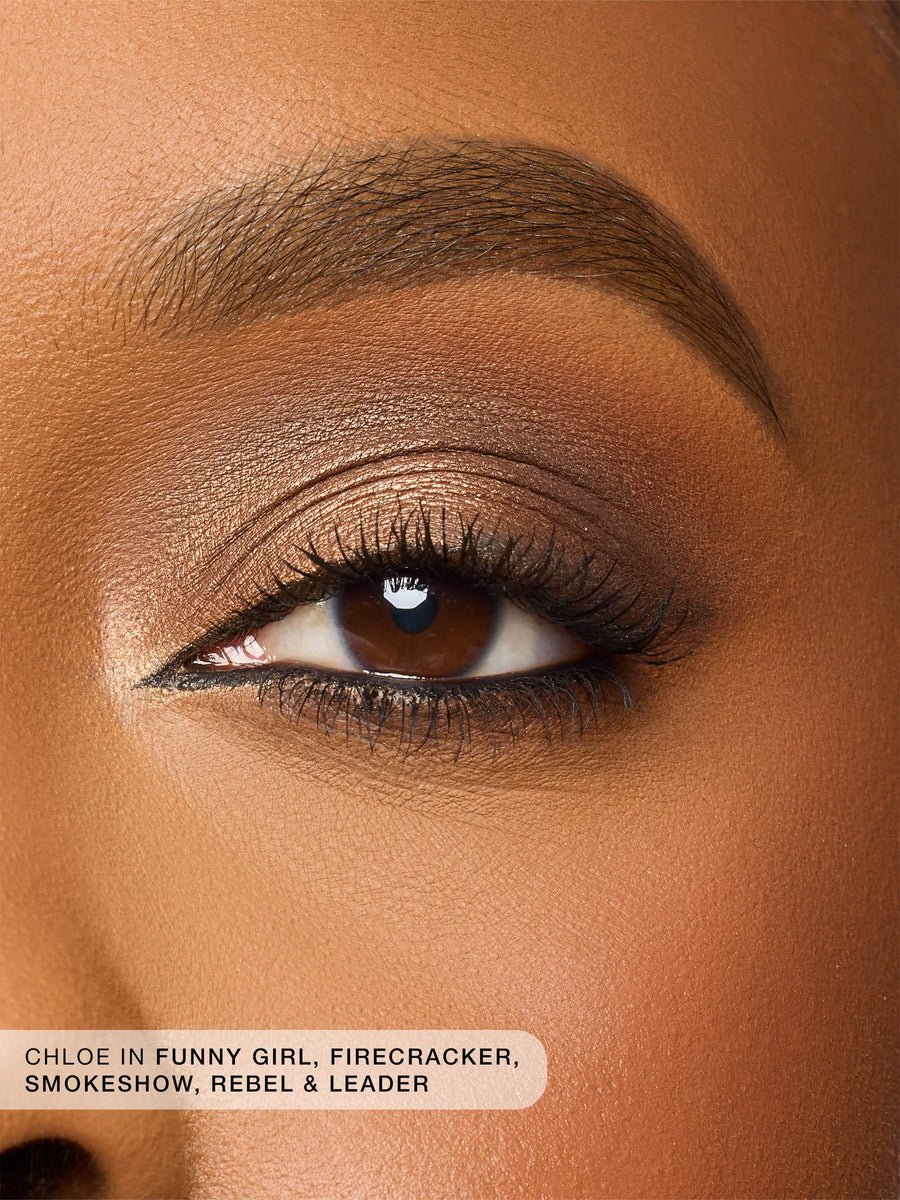 Close-up of a brown eye with makeup, featuring product names.