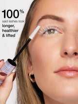 Woman applying mascara with text indicating lash results