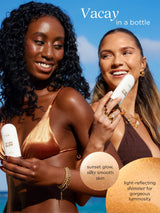 Two women in swimsuits holding sun care products with a blue sky background
