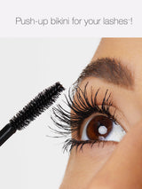 Eyelash extension application with a brush and text 'Push-up bikini for your lashes!'