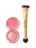 Tarte blush compact open, exposing coral cream and shimmery pink powder; paired with a dual-ended Tarte brush standing upright on a white background. Text: tarte cosmetics kind since '99; tarte.
