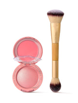 Tarte blush compact open, exposing coral cream and shimmery pink powder; paired with a dual-ended Tarte brush standing upright on a white background. Text: tarte cosmetics kind since '99; tarte.