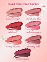 Six lip color swatches smeared and crushed to show powder and cream textures, arranged in two columns on a pale pink gradient background; labels read toasted coconut, strawberry bliss, red velvet, pink champagne, honey blossom, birthday cake; small decorative teacup and ribbon stickers in corners.