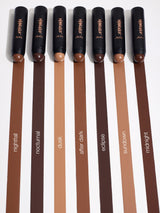 Set of makeup brushes with brown handles and visible brand name on a white background