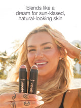 Woman holding tarte makeup products with text about skin tone.