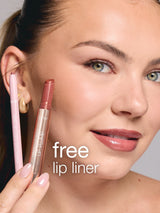 A woman holds Tarte Cosmetics Maracuja Juicy Lip Plump and Maracuja Juicy Lip Liner near her lips. Text reads free lip liner. She has smooth skin and neatly tied-back hair.