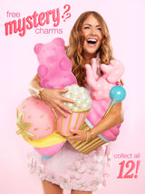 A smiling woman holds oversized pastel snack-shaped charms (giant gummy bear, popcorn tub, lollipop, strawberry, bunny) against a soft pink background. Text: free mystery? charms; collect all 12!