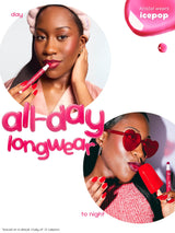 Advertisement for a makeup product with a woman applying lipstick and wearing sunglasses, featuring the text 'all-day longwear' and 'Kristal wears Icepop'.