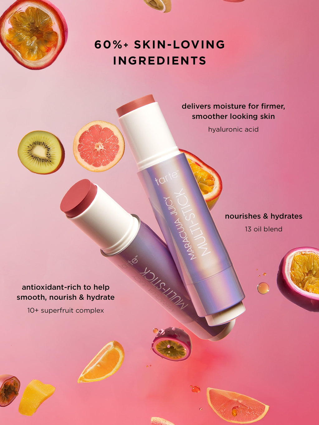 Two lip balms with ingredients on a pink background