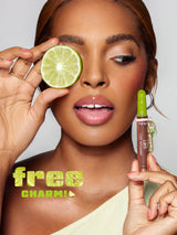 Woman holding a lime slice and a cosmetic product with 'free charm!' text