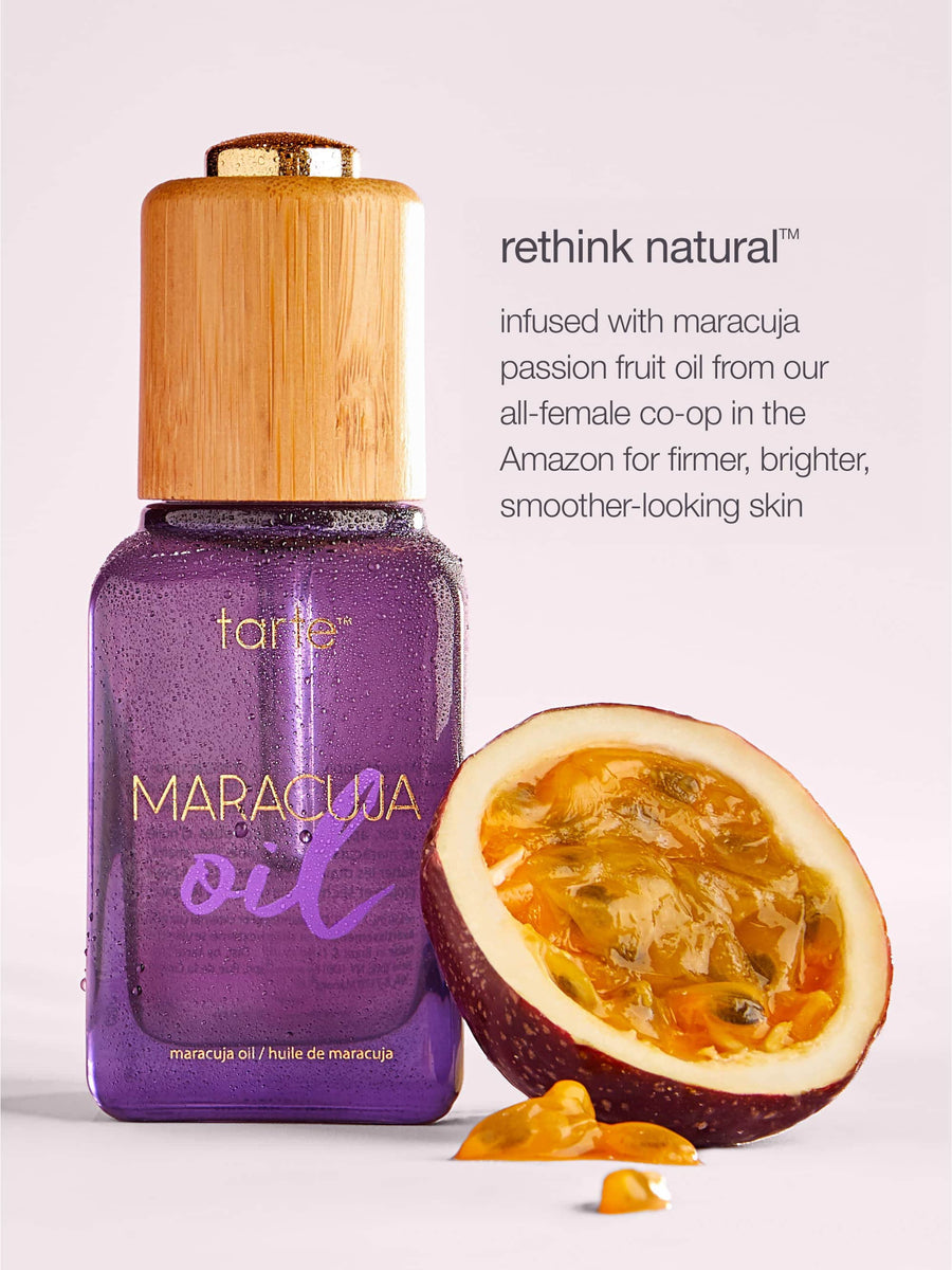 Tarte Maracuja oil bottle with a halved passion fruit on a light background