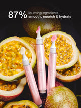 Two lip care products with a pink applicator on a background of passion fruits, highlighting '87% lip-loving ingredients' text.
