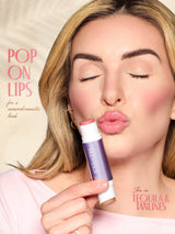 Woman applying tarte double ended multi stick with text about lip color and brand.