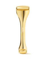 Gold-colored skin exfoliator on a white background