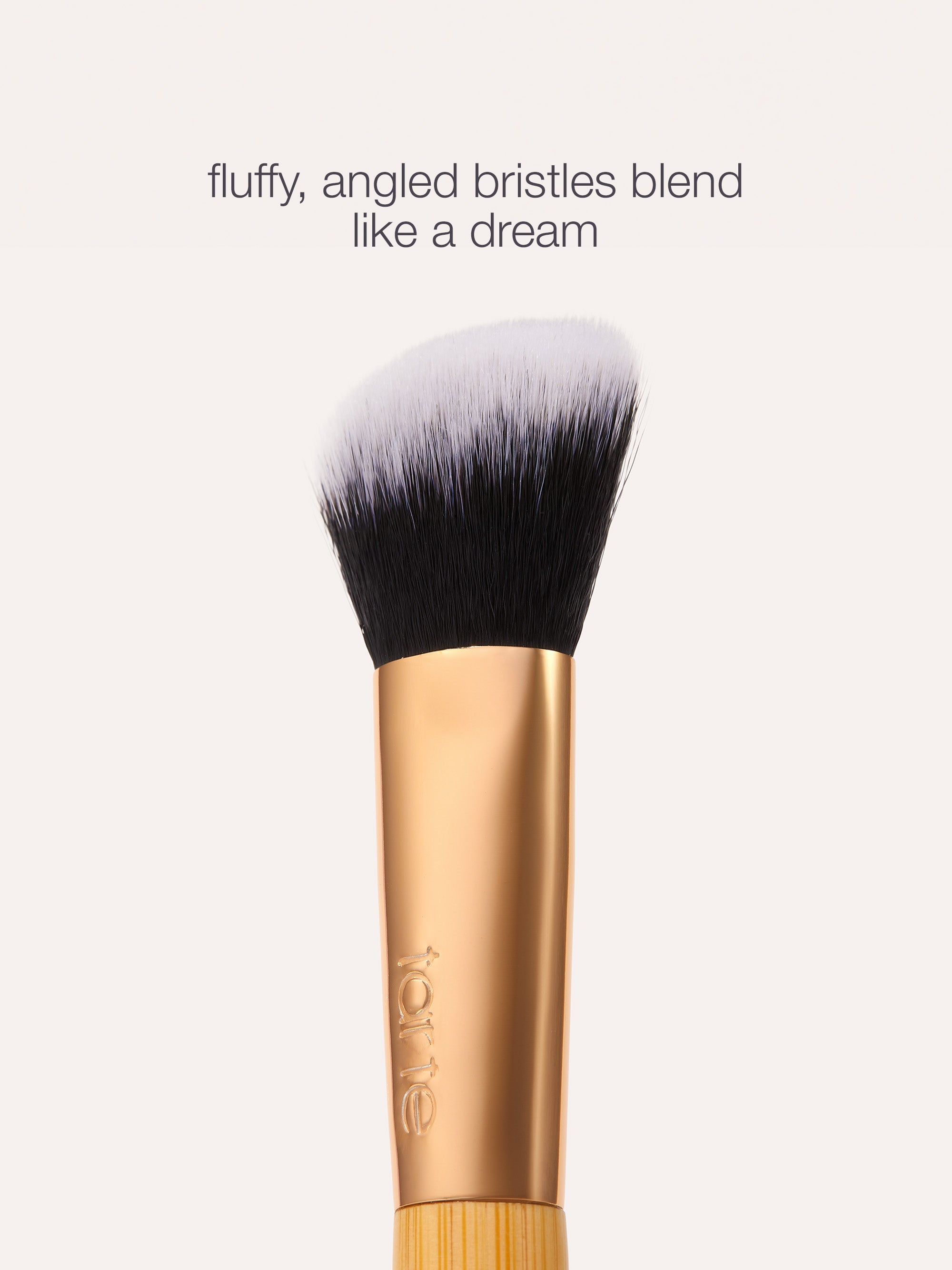Makeup brush with fluffy, angled bristles on a white background