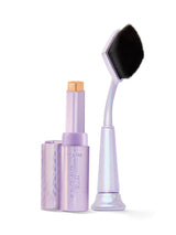 Makeup stick with applicator and brush on a white background