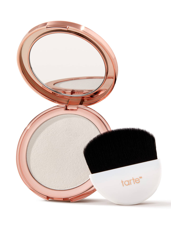 Compact powder with a brush on a white background, featuring the Tarte brand.