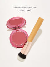 Pink cream blush with a brush on a white background