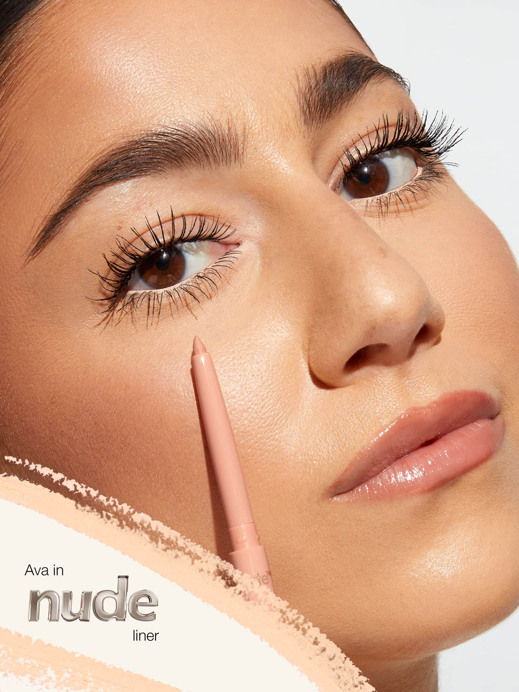 Close-up of a woman's face wearing tarte fake awake labeled 'Ava in nude liner'.
