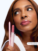 Woman holding maracuja juicy lip liner, and  maracuja juicy lip with a white background