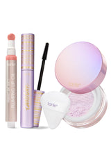 Makeup products including maracuja juicy lip oil, tubing mascara and setting powder trio with a white background