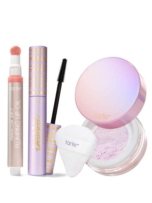 Makeup products including maracuja juicy lip oil, tubing mascara and setting powder trio with a white background