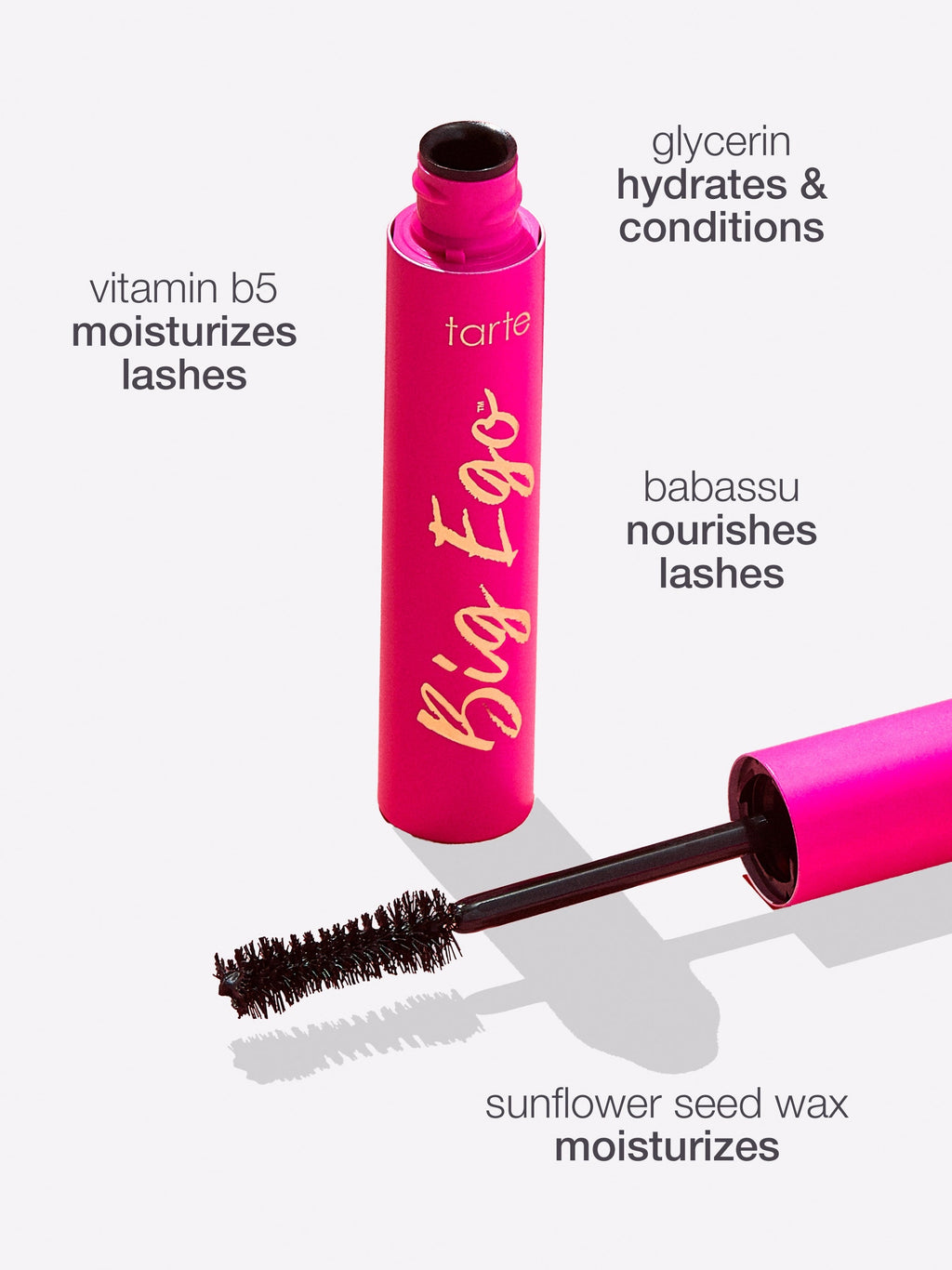 Pink Tarte Cosmetics mascara tube labeled Big Ego, displayed alongside wand. Text describes ingredients: vitamin B5 moisturizes lashes, glycerin hydrates and conditions, babassu nourishes lashes, sunflower seed wax moisturizes.