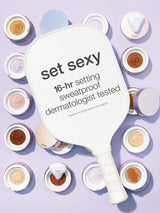 Makeup setting powder paddle with 'set sexy' text on a purple background