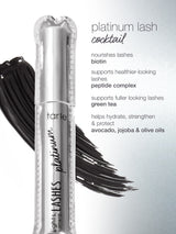 A silver mascara tube labeled tarte lights, camera, lashes platinum rests on a black mascara smear. Text lists ingredients: platinum lash cocktail, nourishes lashes biotin, supports healthier-looking lashes peptide complex, supports fuller looking lashes green tea, helps hydrate, strengthen & protect avocado, jojoba & olive oils.