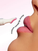 Lip balm with a curved applicator being used on lips, labeled 'custom curved lip scoop'.