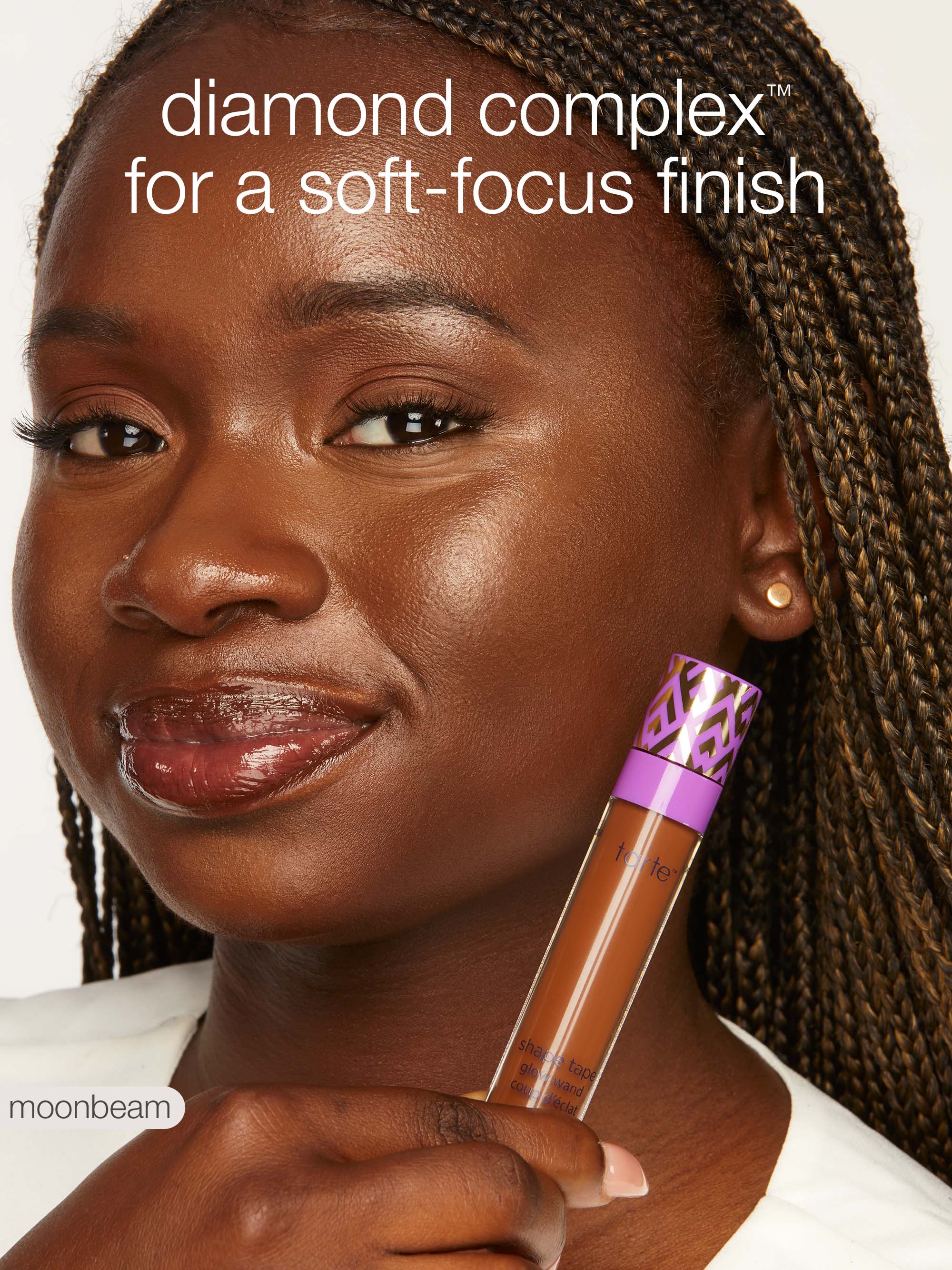 Woman holding a makeup product with text about 'diamond complex' finish