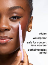 Person applying tartelette quick stick tubing liner with a pen, focusing on the product and its features.