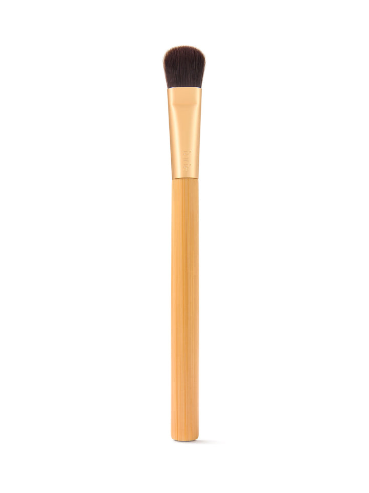 Makeup brush with wooden handle on a white background