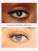 Close-up of eyes with natural makeup application on a plain background