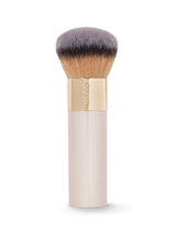 Makeup brush with gold and beige handle on a white background